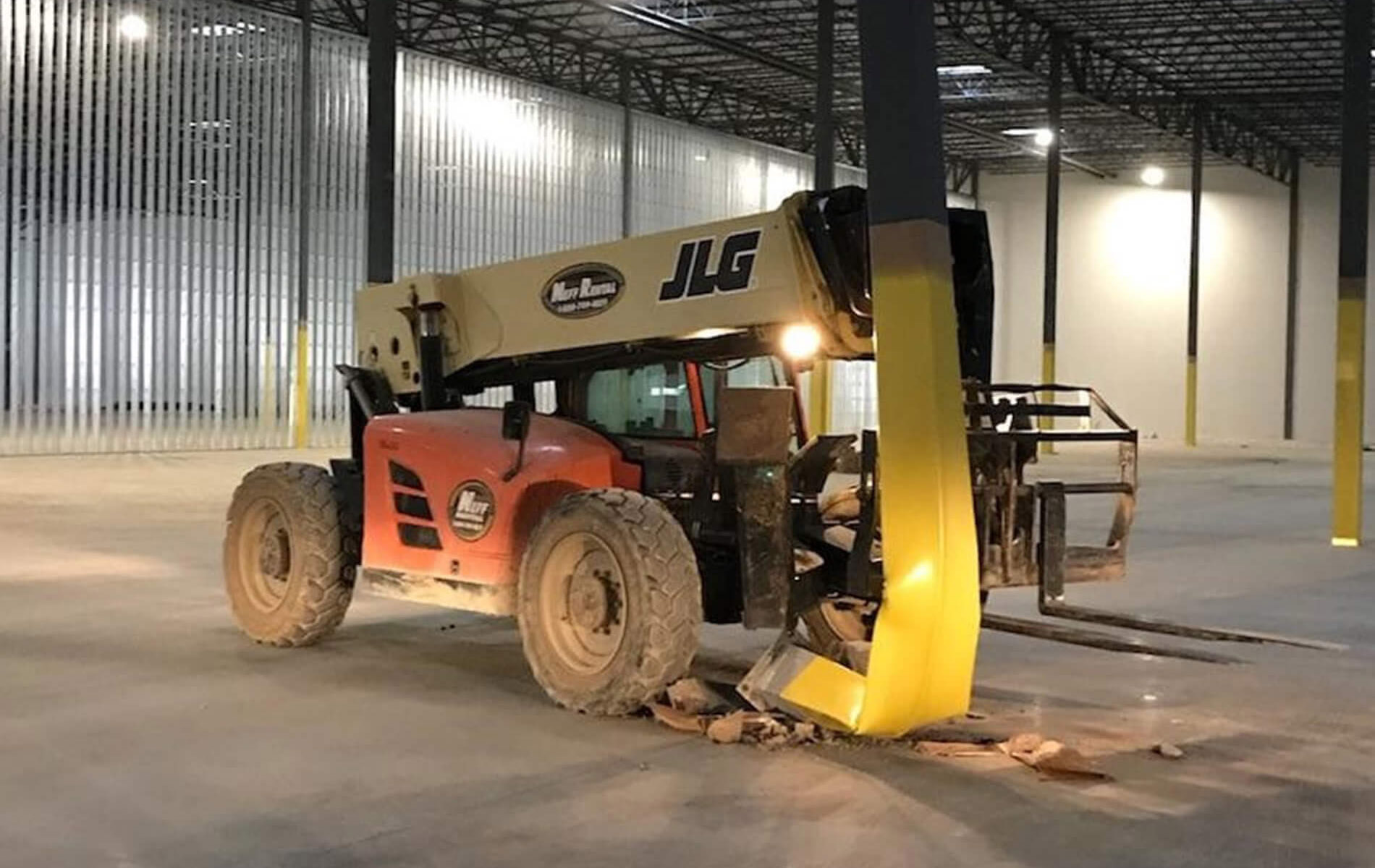 Dramatic photo of a forklift that smashed a support column in a warehouse