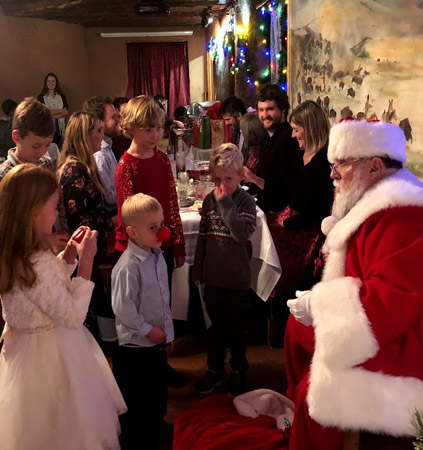 Kids talking with Santa at Peak Christmas party